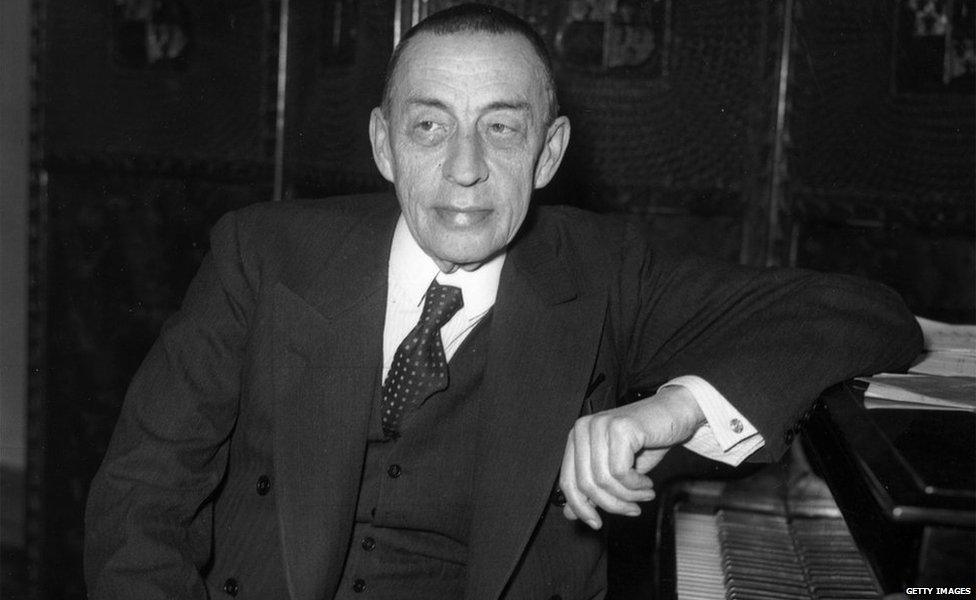 An archive black and white photo of Sergei Rachmaninoff sitting at a piano in 1938