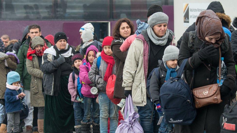 A line of people wearing warm clothes against the cold