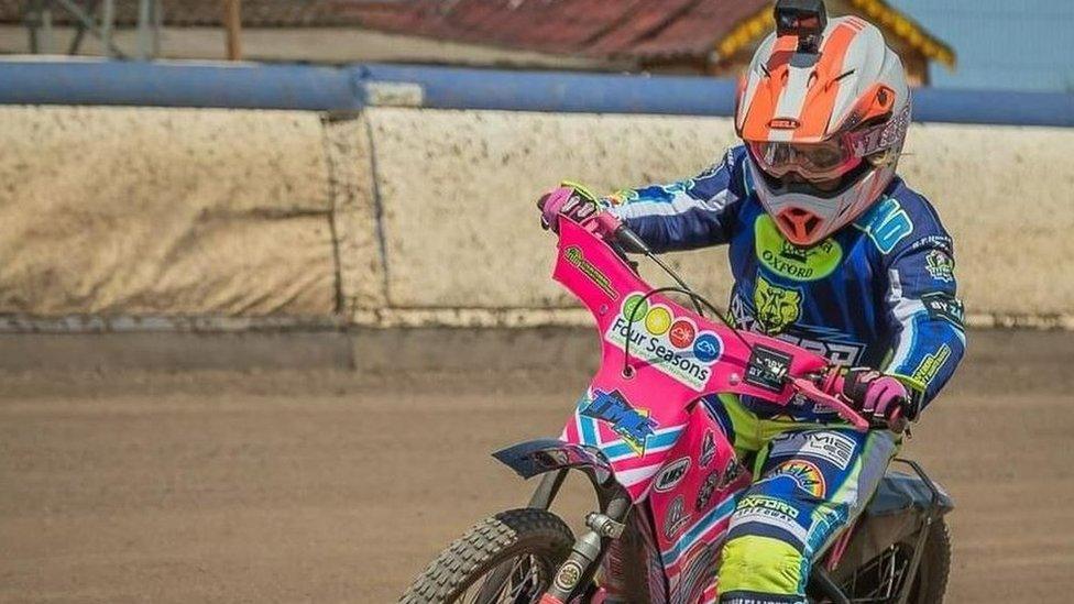 Chloe riding her bike on the speedway track