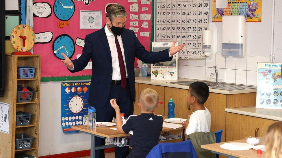 Labour Party leader Sir Keir Starmer talks with children during a visit to Forge Integrated Primary School in Belfast.