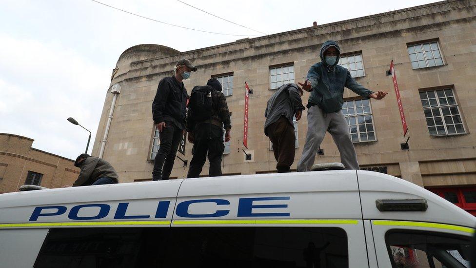 Protestors climbed on top of a police van