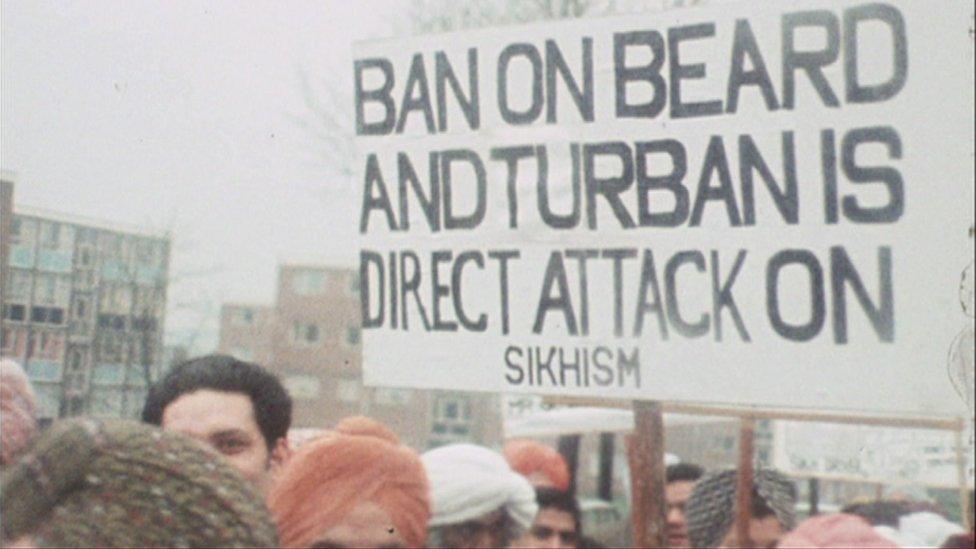 Sikhs striking in Wolverhampton with sign reading 'Ban on beards and turban is direct attack on Sikhism'