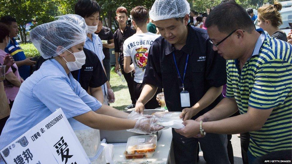 Rescue workers hand out meals