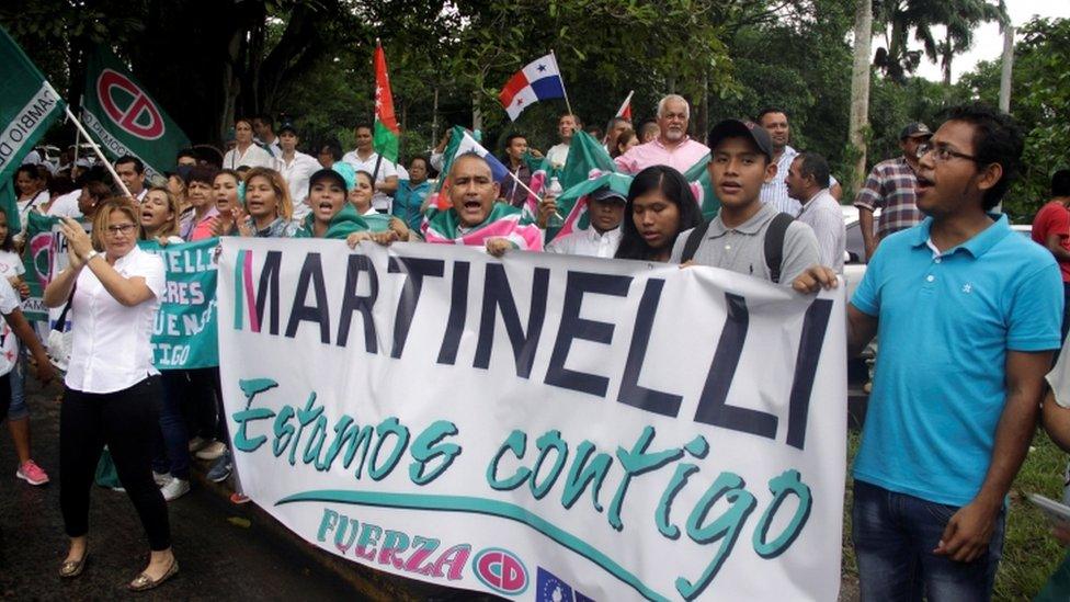 Supporters of former Panama president Ricardo Martinelli hold a banner reading: "Martinelli, we are with you" during a protest outside the Supreme Court in Panama City, Panama June 11, 2018