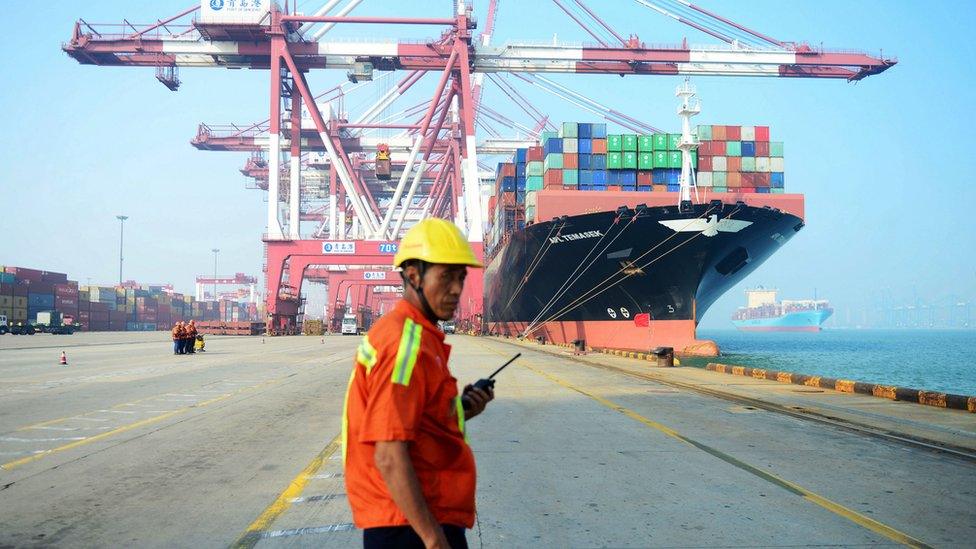 A man stands on a port in China