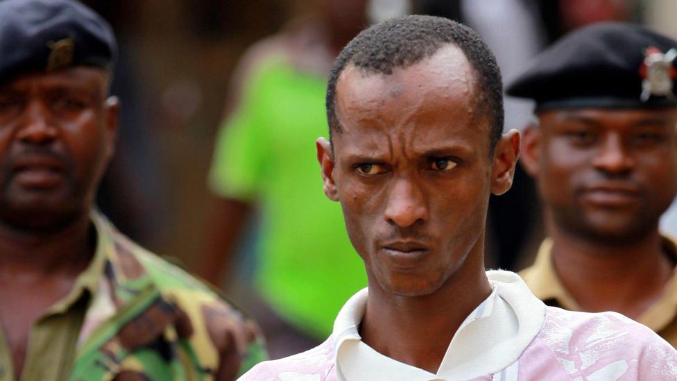 Ali Babitu Kololo, a former employee of the Kiwayu Safari Village, is escorted by police to the cells after he was sentenced to death for robbery July 29, 2013.