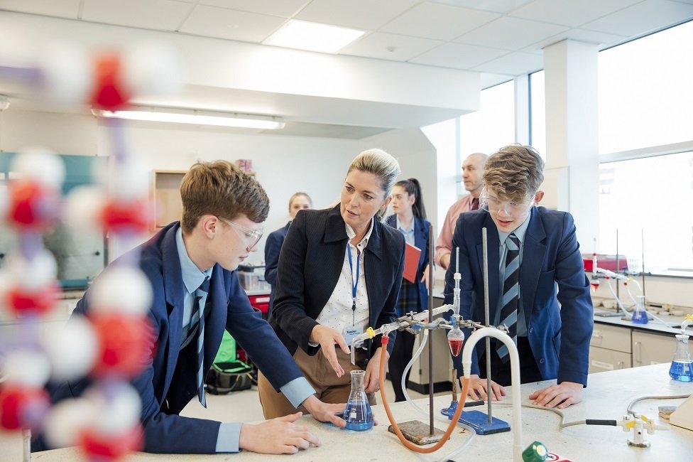 Teacher with pupils in science lab