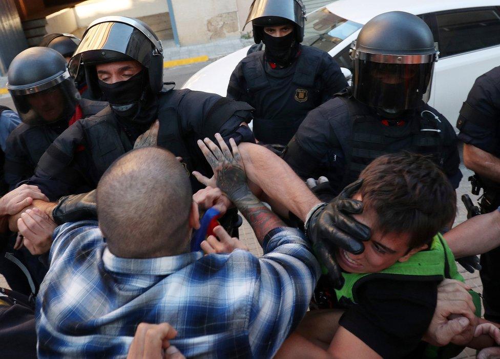 Police grapple with protesters outside Unipost office in Terrassa on 19 Sept