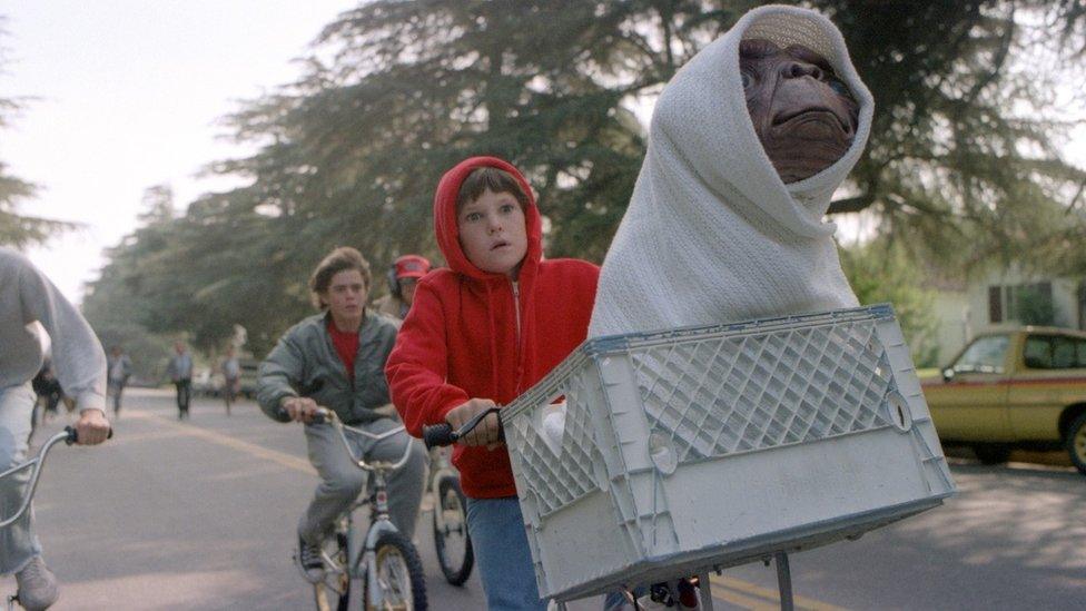 Elliott and E.T. on a bike in the 1982 blockbuster film