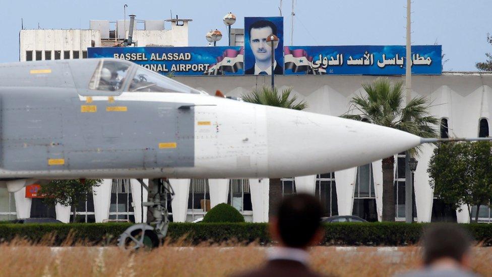 Russian Su-24 bomber passing by a portrait of Syrian President Bashar al-Assad at Hmeimym airbase in Syria (4 May 2016)