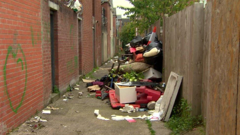 Fly-tipping in an alleyway