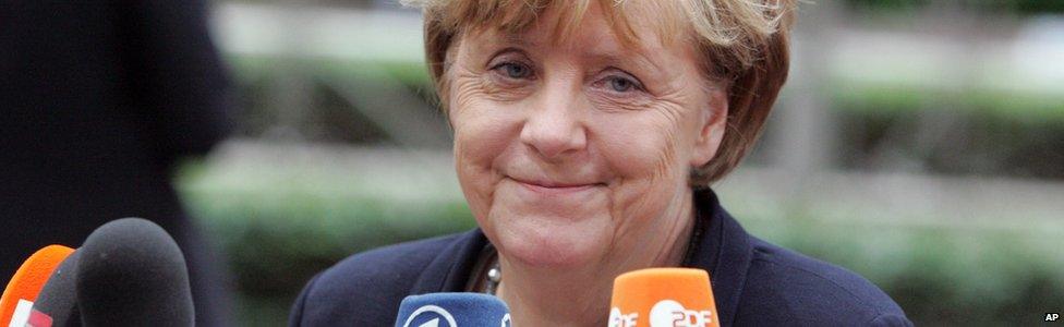 German Chancellor Angela Merkel speaks to the media as she arrives for an emergency summit of eurozone heads of state or government at the EU Council building in Brussels on Tuesday, July 7, 2015.