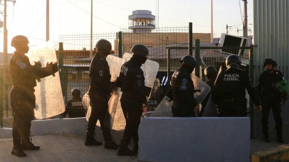 Police officers stand outside a penitentiary during a fight among inmates in Villahermosa, in Tabasco state, Mexico June 22, 2021