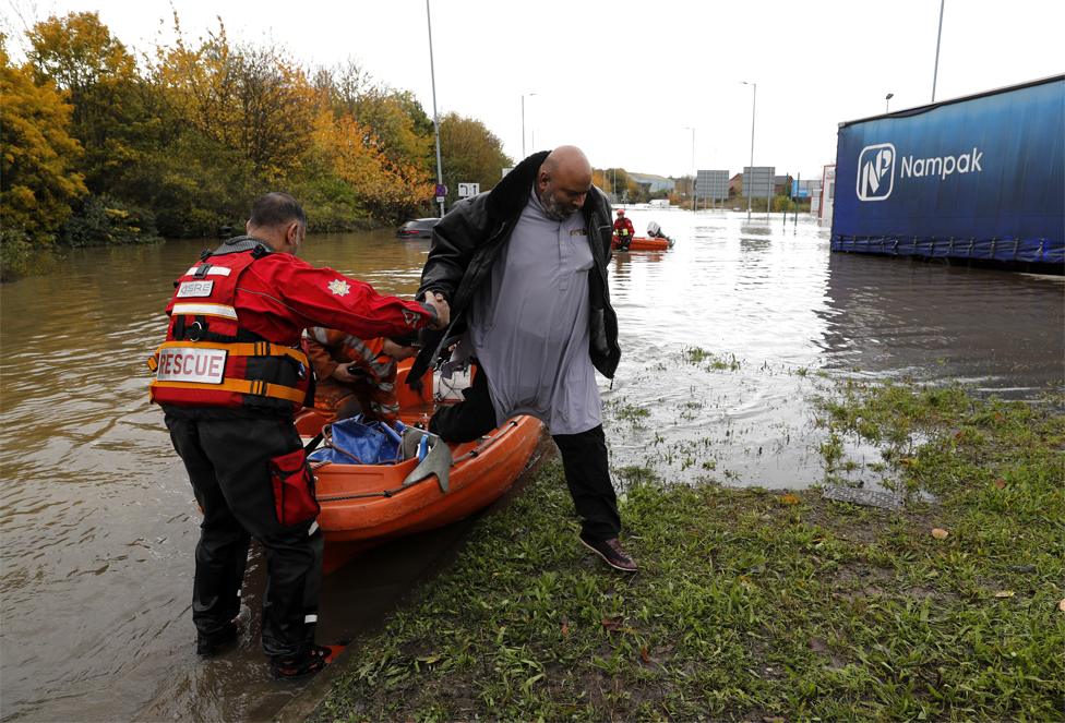 A man is rescued from flood waters