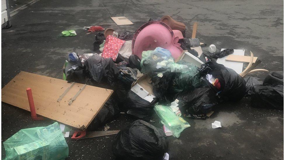 A pile of rubbish dumped on a road