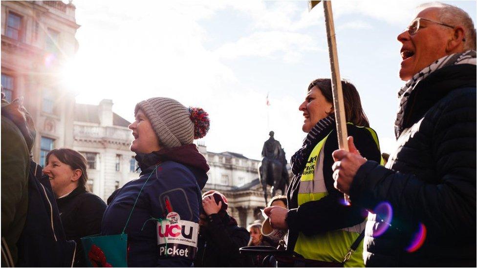 UCU members in London hold signs and chant