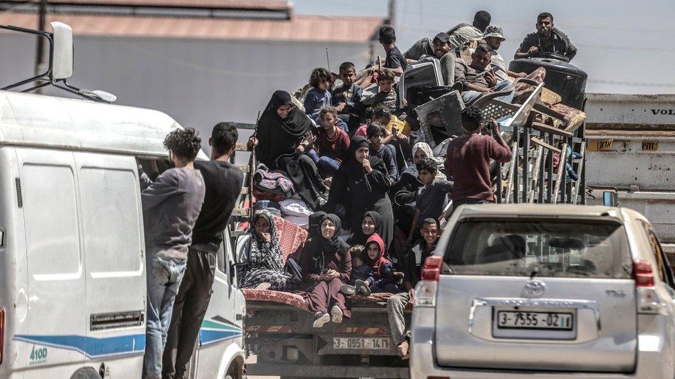 Palestinians cram on to a van after deciding to flee Rafah, as Israeli forces continue a ground operation in the southern Gaza city (8 May 2024)