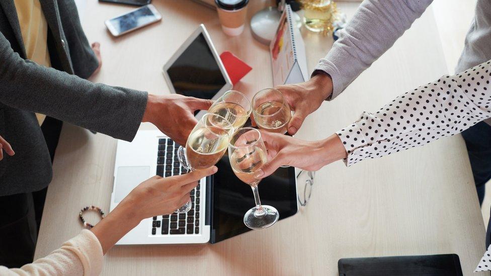 people holding glasses of wine