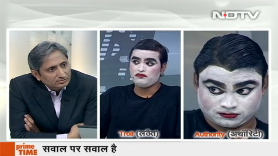 A screen grab of Ravish Kumar and the two mimes in face paint