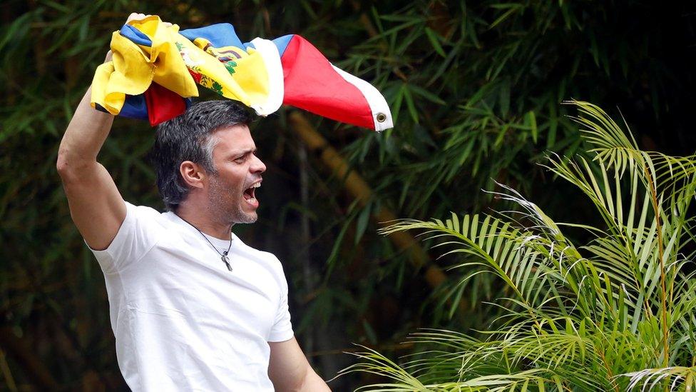 Leopoldo López climbed on his roof to greet supporters after being released from prison to house arrest, 8 July