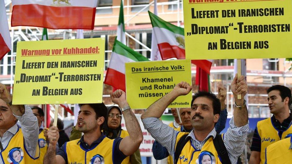 Supporters of the National Council of Resistance of Iran (NCRI) hold placards reading "Deliver the Iranian 'diplomat'-terrorist to Belgium" in Berlin, Germany (11 July 2018)