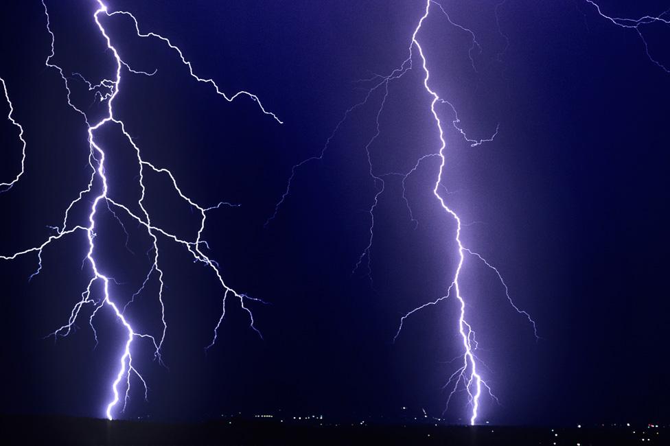 Two enormously powerful cloud-to-ground lightning strikes above Tucson, Arizona, USA in 2008