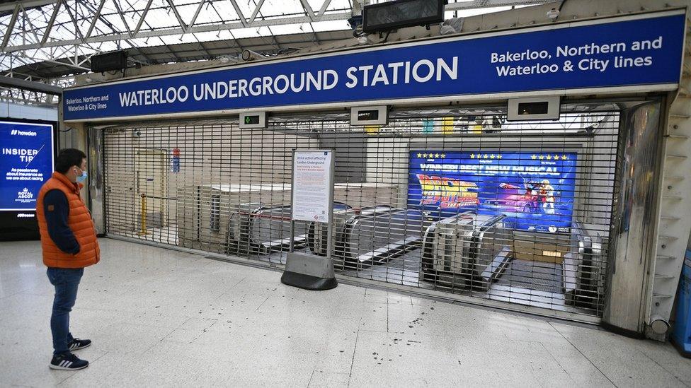 A commuter looks at a closed Waterloo undergrond station