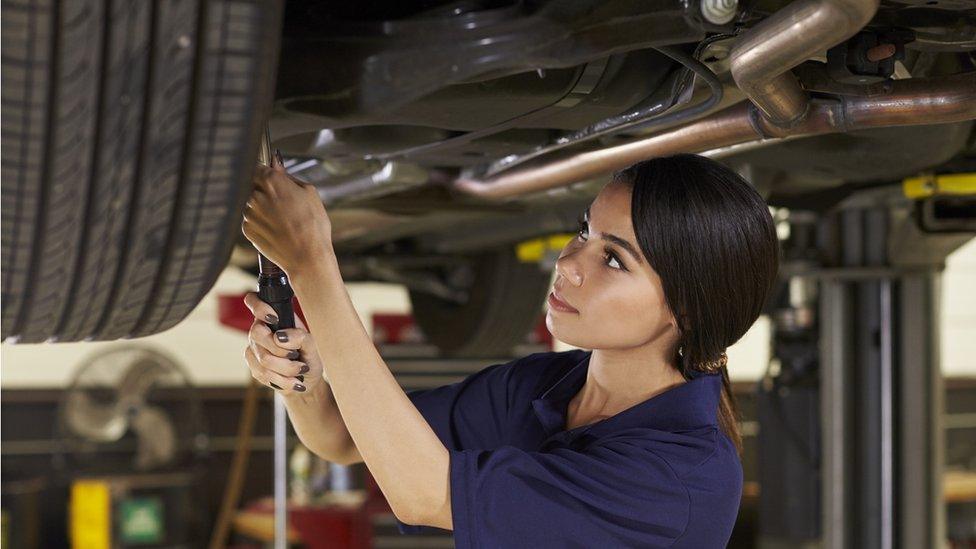 Woman mending car