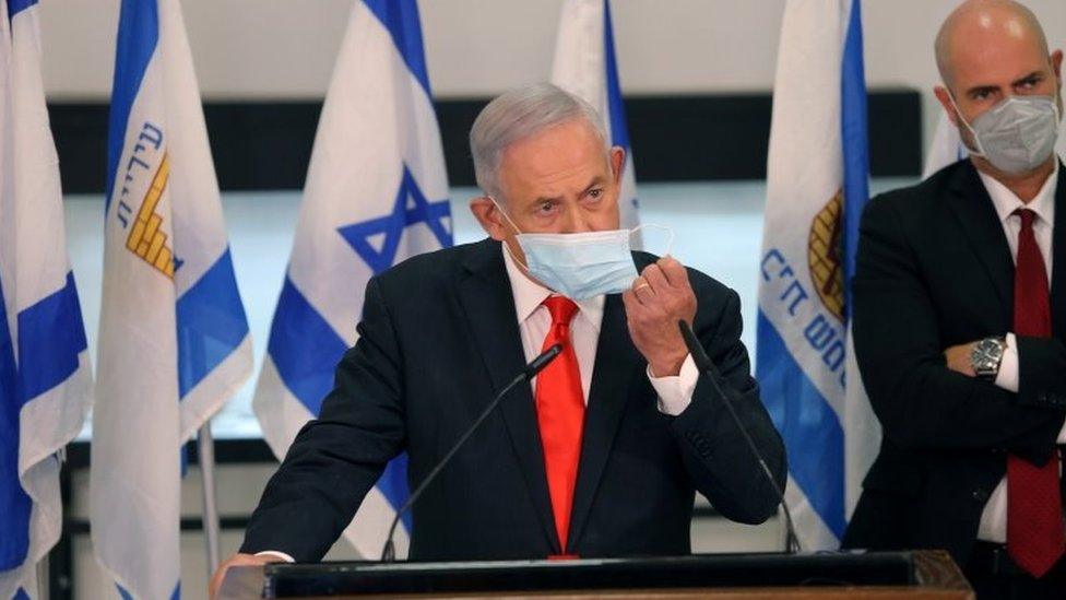 Israeli Prime Minister Benjamin Netanyahu adjusts his face mask while announcing night-time curfews in 40 "red" areas (8 September 2020)