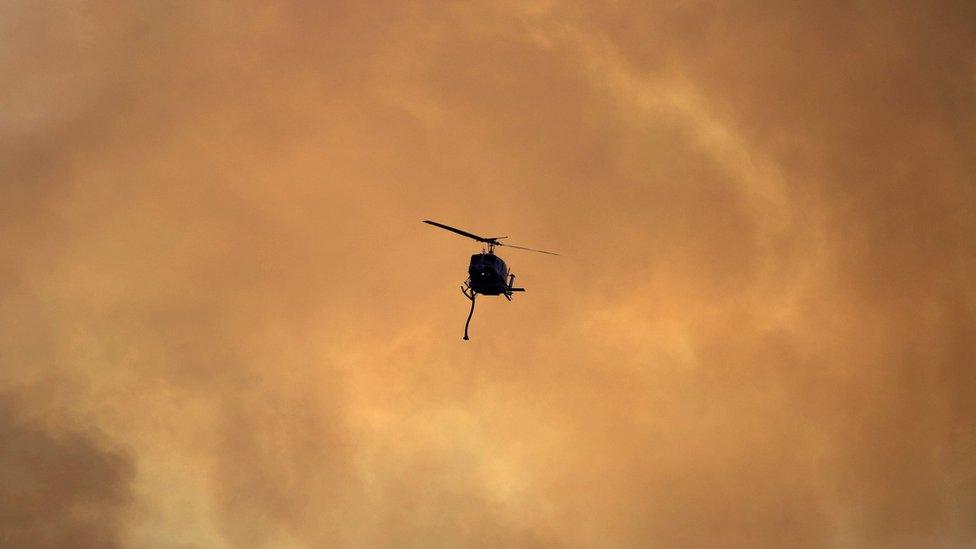 Helicopter battles fires in California