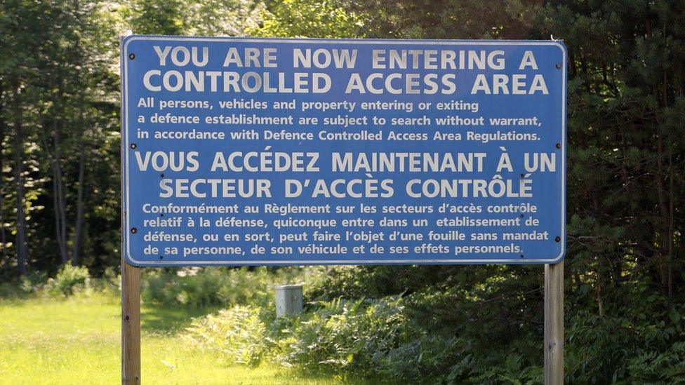 A large sign on the grounds of a Borden base warns that "you are now entering a controlled access area"