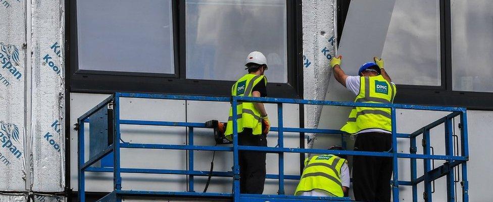 Cladding being removed from a building