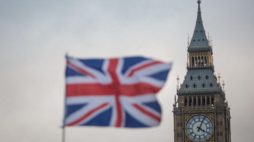 Elizabeth Tower with Union jack out of focus in foreground