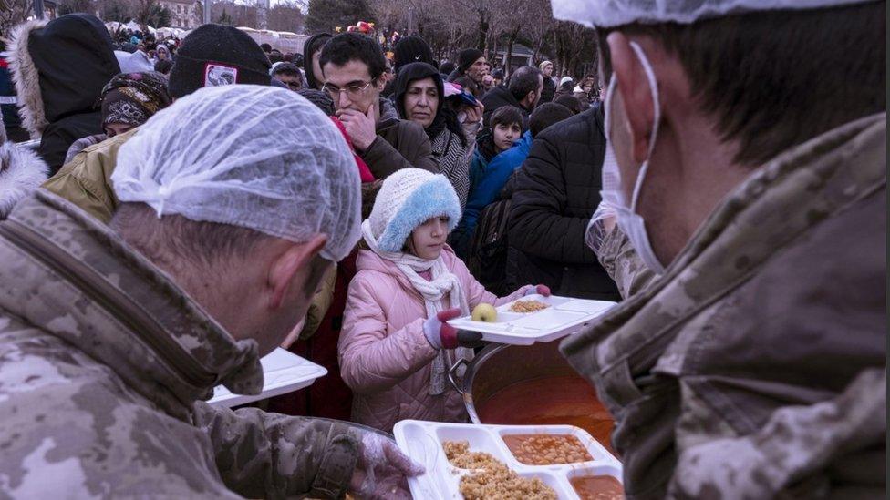 People receive free meals after an earthquake in Diyarbakir, southeast of Turkey