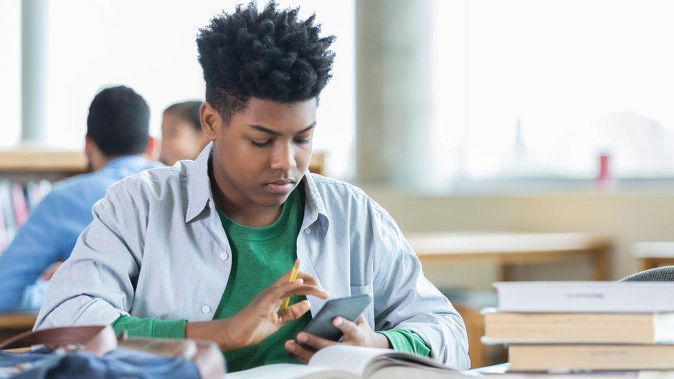 A student studies for an exam while in the campus library