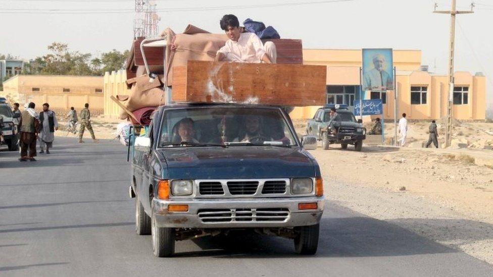 Afghan residents leave their home after a battle with the Taliban in Kunduz Province, Afghanistan (28 Sept 2015)