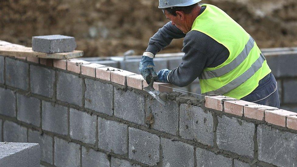 Bricklayer laying bricks