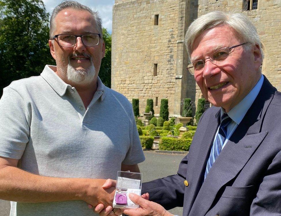 Warrick Rochester (left) and Dr Stuart Madnick, owner of Langley Castle (right), showing a wax imprint of the seal for the cameras.