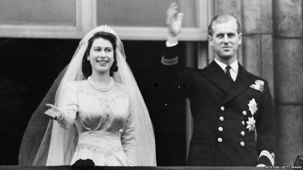 Princess Elizabeth and Prince Philip on their wedding day waving from a balcony