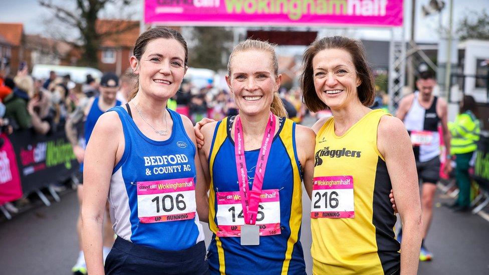 Three female runners posing for a photo together