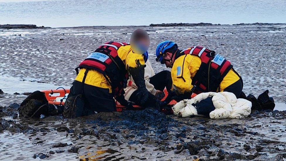 Woman being rescued from the mud