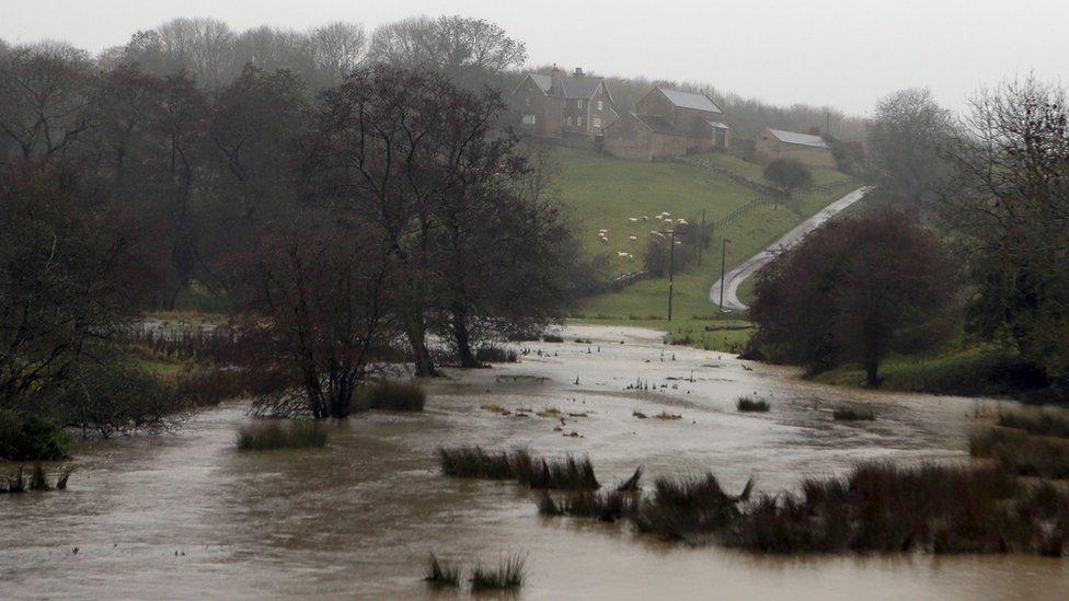 A field near Nettleton, Wiltshire, is flooded due to the high amounts of rain as Storm Angus continues to sweep across the UK.