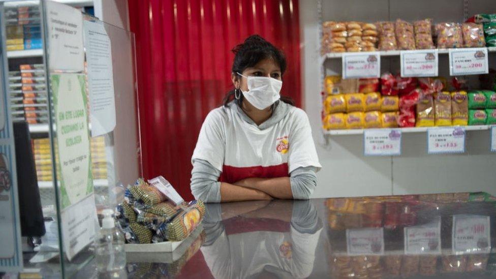 A seller waits for customers at the Central Market in Buenos Aires, Argentina, Saturday, April 3, 2020