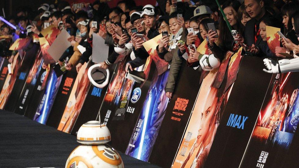 Chinese fans take pictures of the droid character BB-8 at the Shanghai premiere of "Star Wars: The Force Awakens"