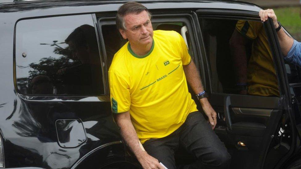 Brazil's President Jair Bolsonaro arrives at a polling station to vote on Sunday