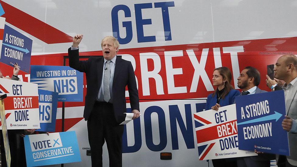 Prime Minister Boris Johnson addresses his supporters prior to boarding his General Election campaign trail bus on November 15, 2019 in Manchester, England.