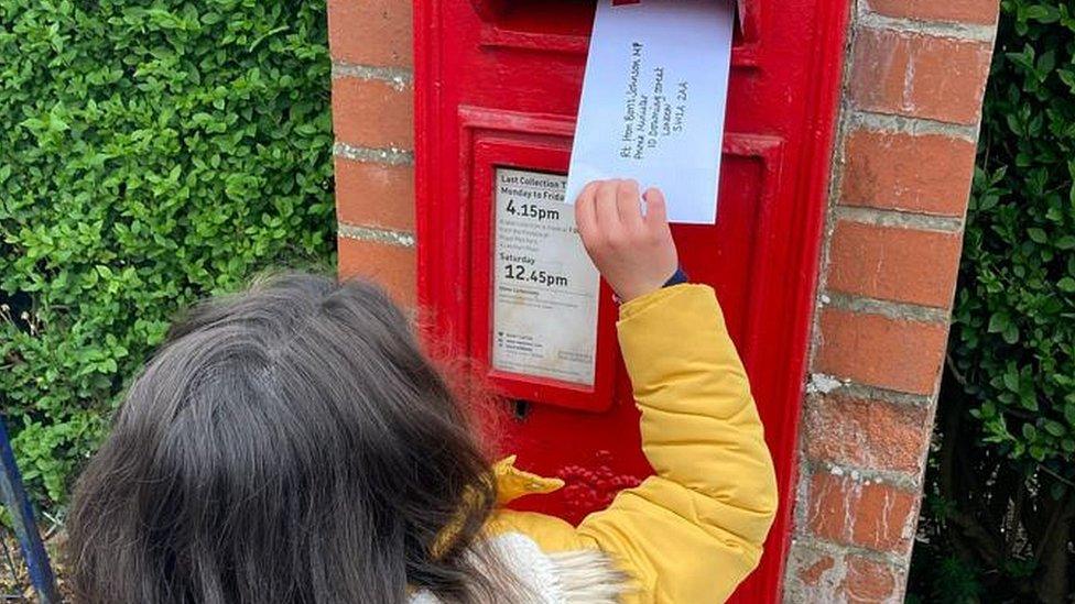 Child posting letter