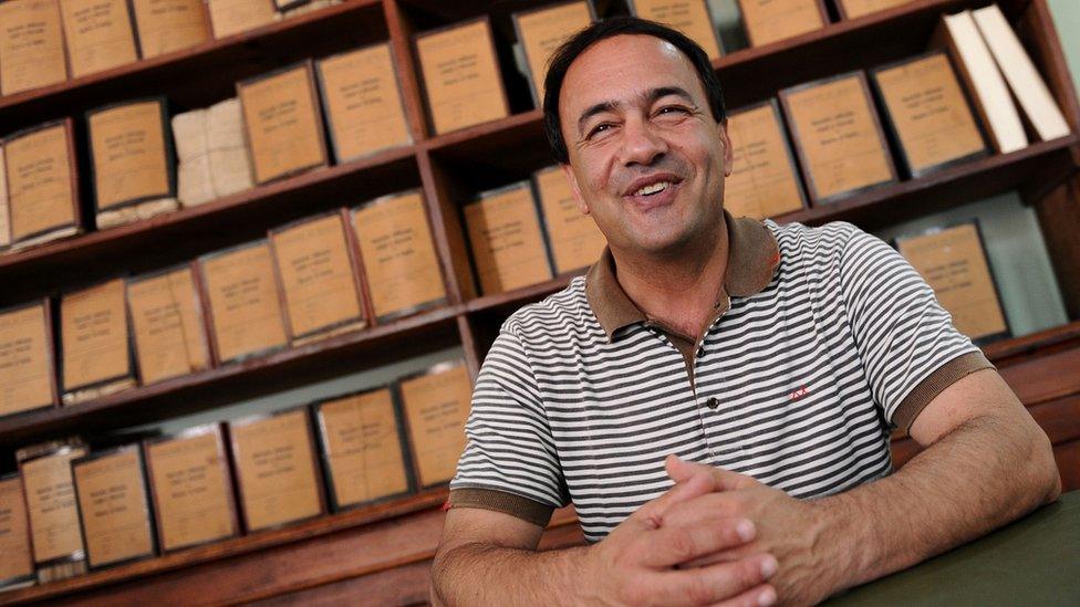 Riace mayor, Domenico Lucano poses in his office in 2011