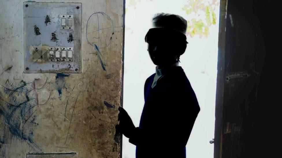 A child stands inside a mosque in Mehrauli