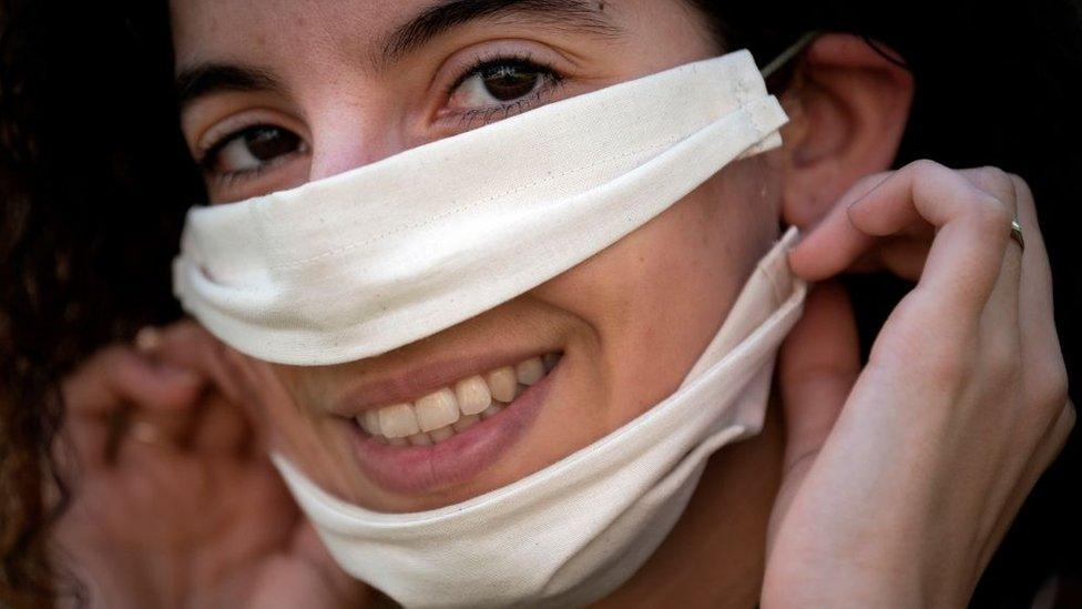 woman wearing mask with clear window